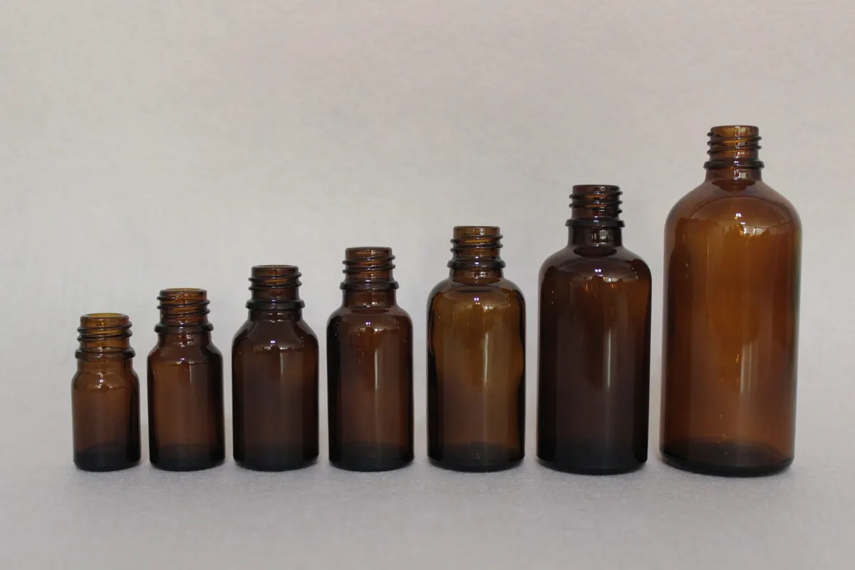 Small amber glass bottle with closure suited for nail treatment and cuticle oil formulas