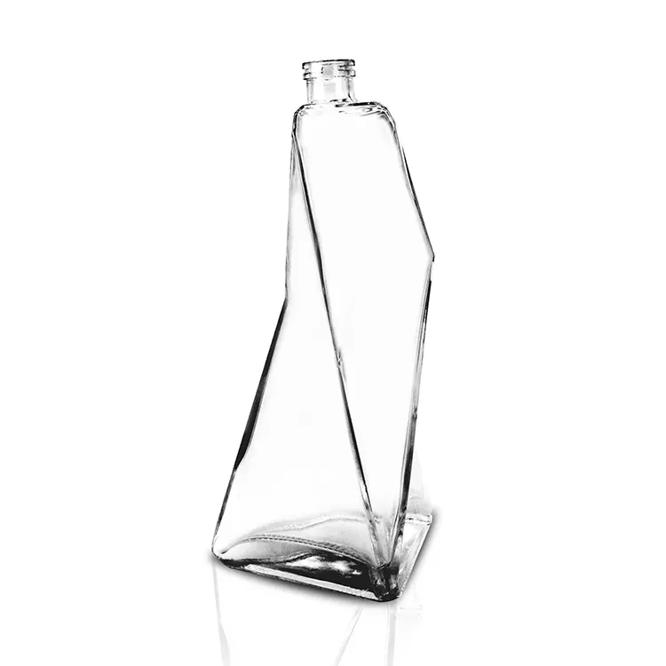 Geometric paneled frosted glass bottle offering grip texture for shampoo and conditioner packaging