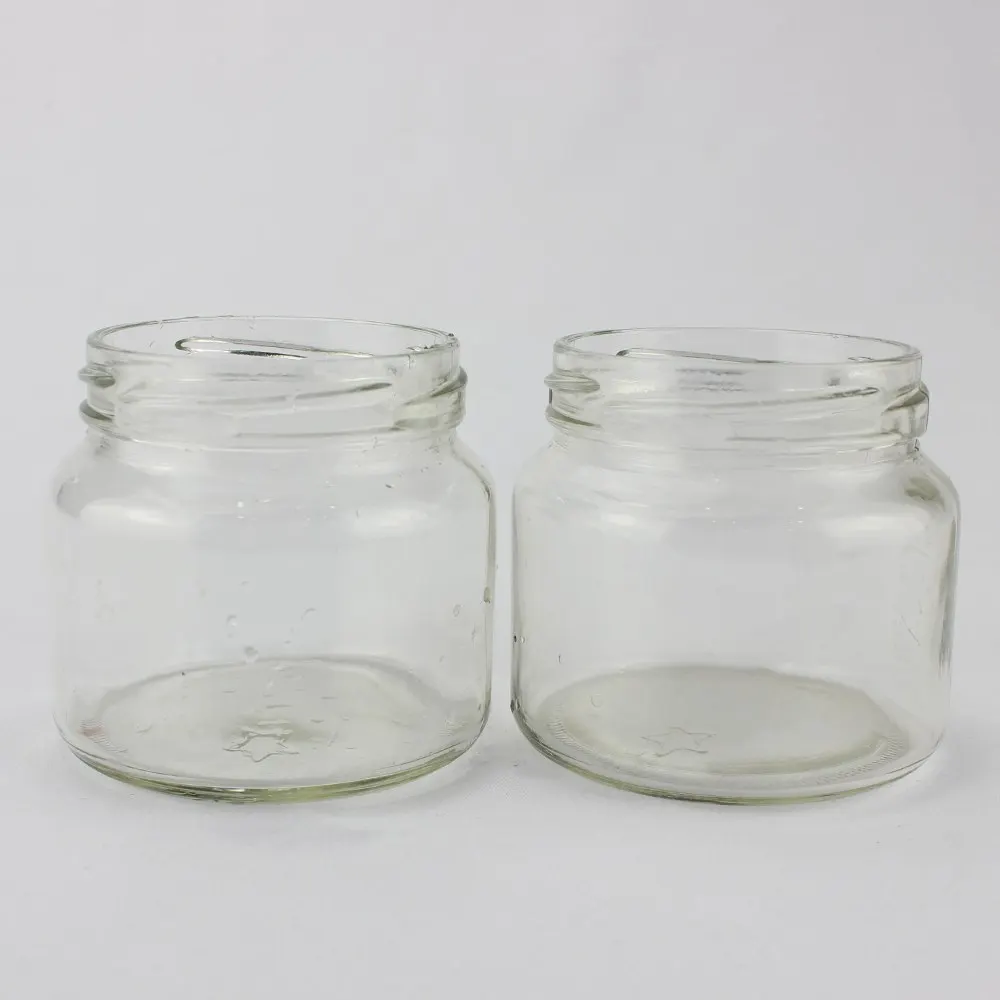 black glass jars with matched closures ready for filling lines