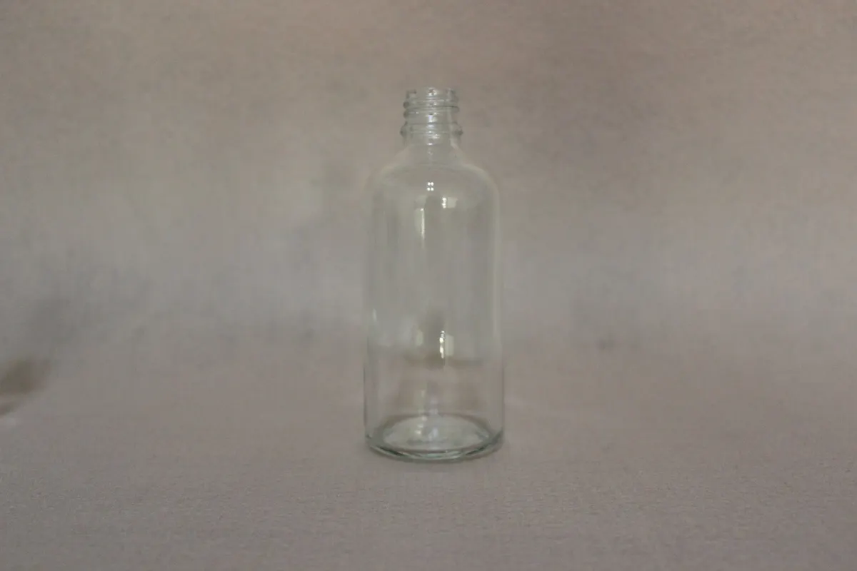boston round glass bottle with cap with matched closures ready for filling lines