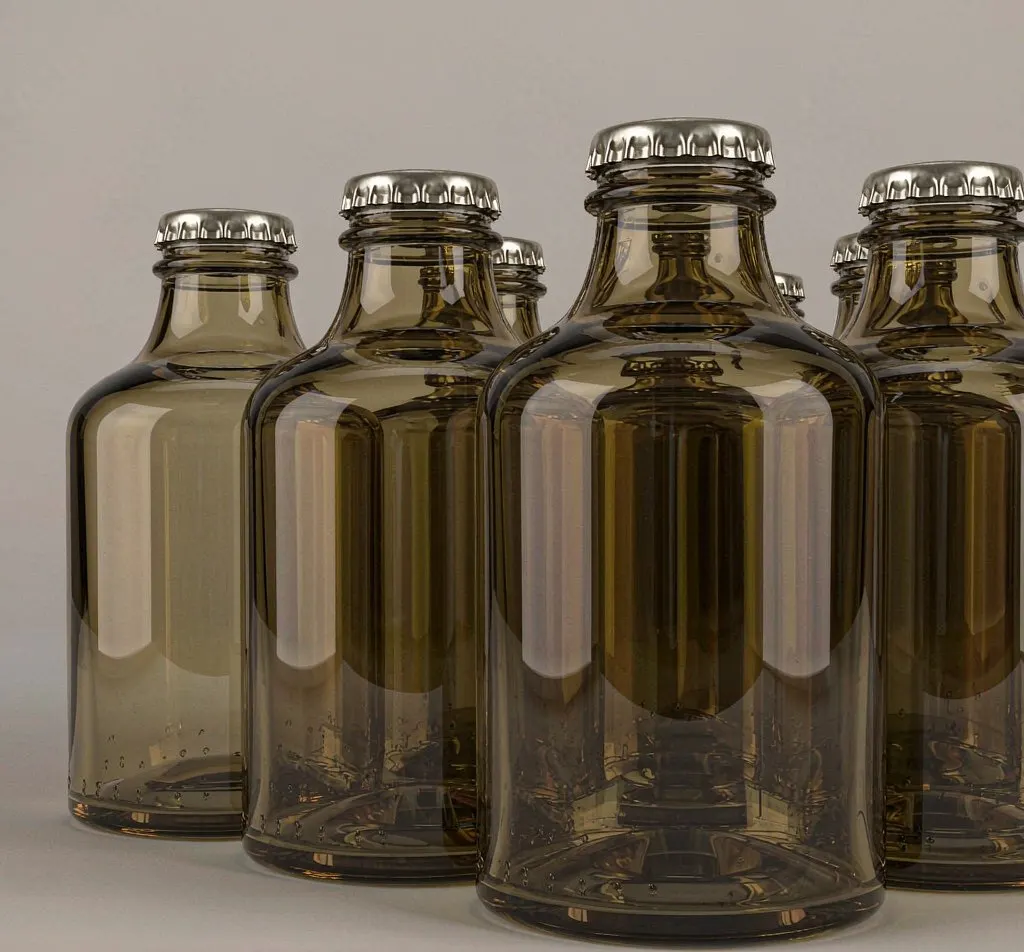 Short stubby amber glass beer bottles with crown caps in a row