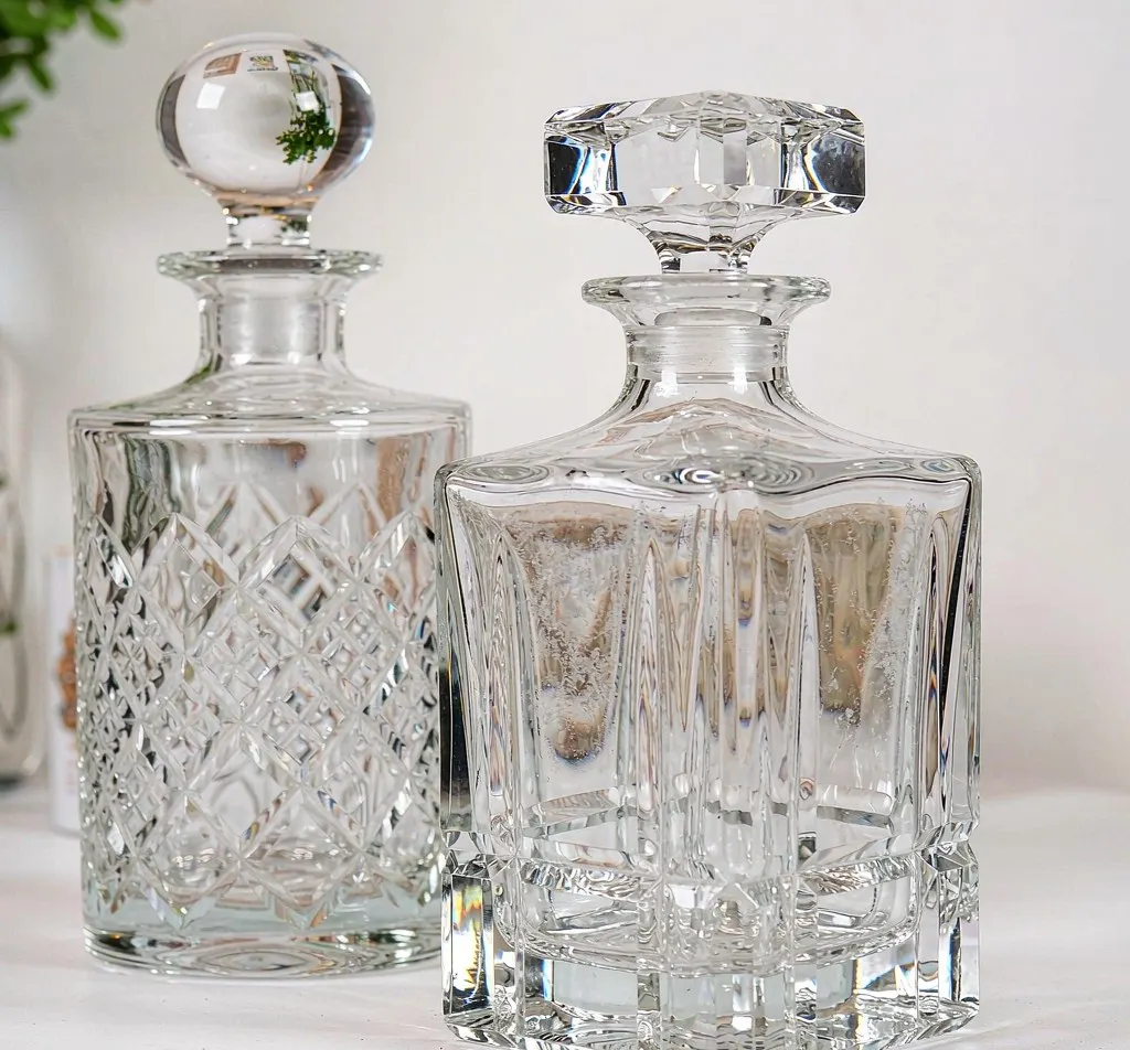 Lead-free crystal glass decanter bottles with glass stoppers on studio background