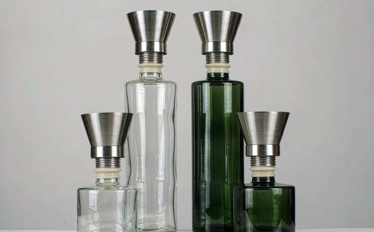 Clear and green glass oil and vinegar cruets with stainless pour spouts