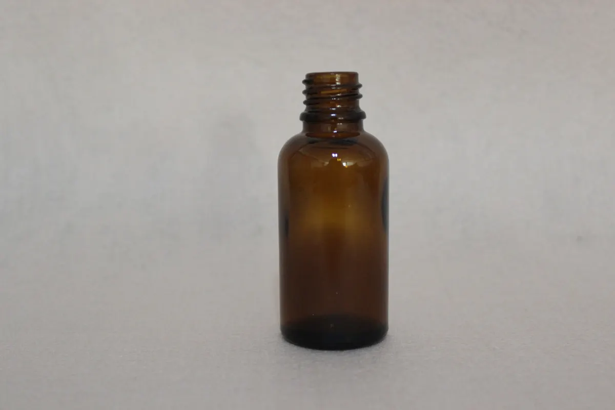 Amber essential oil glass bottles with dropper caps ready for shrink band application