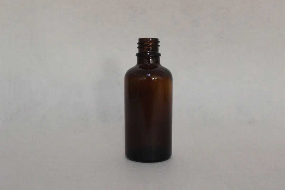 Essential oil bottles staged for closure and tamper band fit testing