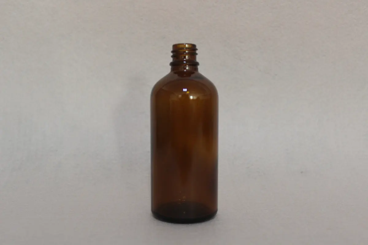 Finished essential oil bottles with tamper-evident shrink bands applied at the neck